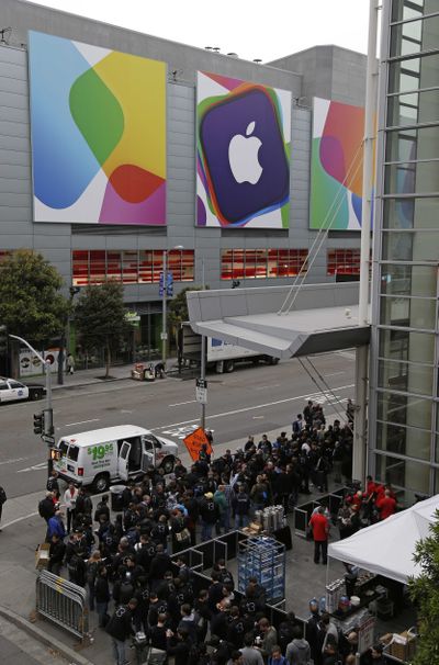 Crowds line up around the Moscone West Center for the opening of the Apple Worldwide Developers Conference in San Francisco on Monday. (Associated Press)