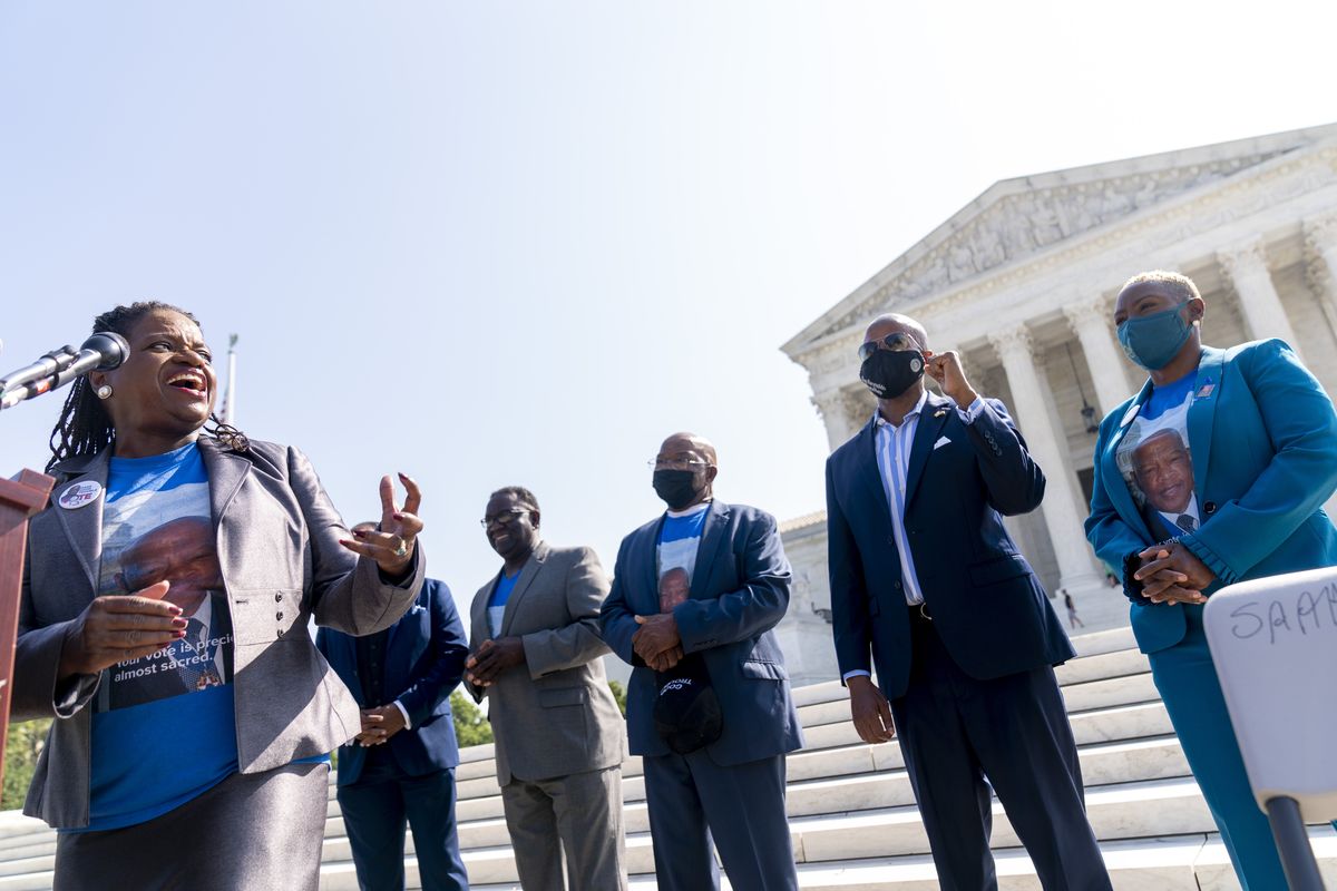 From left, Transformative Justice Coalition President and Founder Barbara Arnwine, accompanied by the brothers of the late Rep. John Lewis, D-Ga., Henry Lewis and Samuel Lewis, Democratic Texas State Rep. Ron Reynolds from Missouri City, and the niece of the late Rep. John Lewis, D-Ga., Angela Lewis Warren, speaks during a voting rights rally on the steps of the Supreme Court in Washington, Wednesday, Aug. 11, 2021. A year after his passing, the brothers and niece of the late Congressman John Lewis join Barbara Arnwine with the Transformative Justice Coalition and others to demand Congress and President Joe Biden do whatever it takes to pass the For the People Act and the John R. Lewis Voting Rights Act.  (Andrew Harnik)