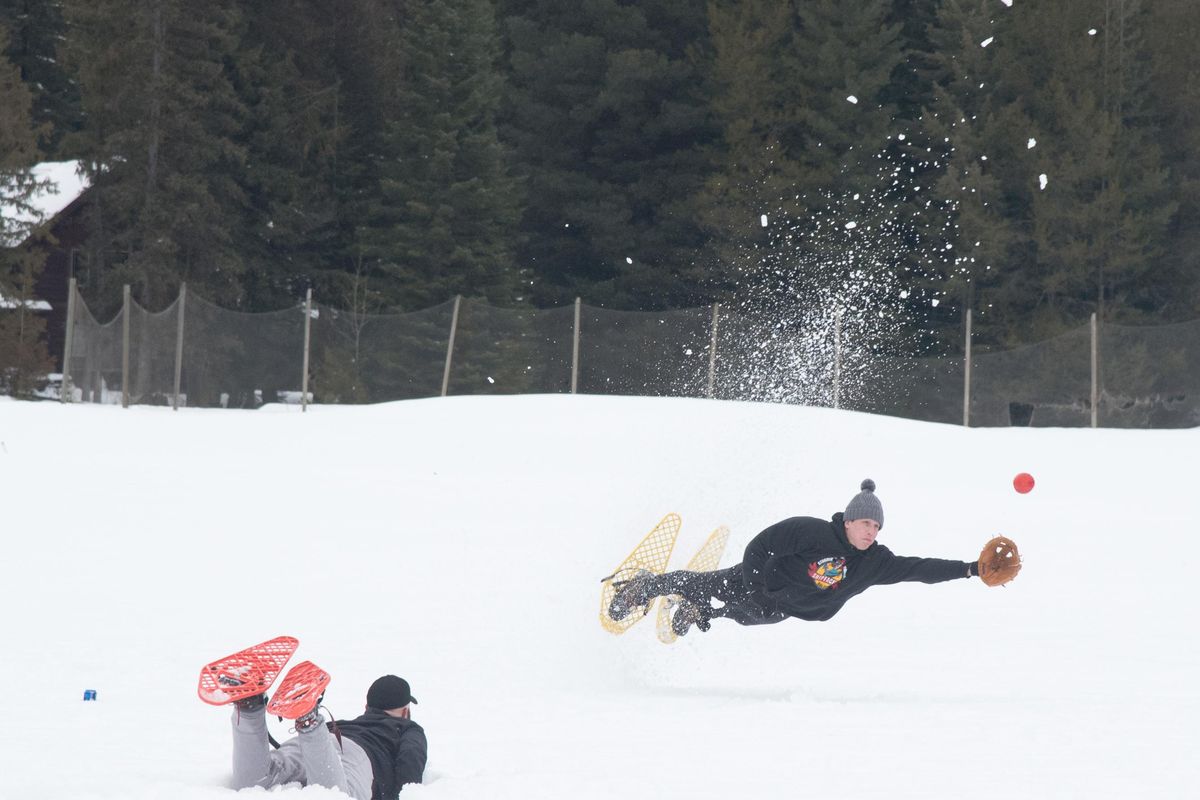 An outfielder dives for a ball during the 50th annual Snowshoe Softball Tournament in Priest Lake on Saturday Jan. 12, 2019. The tournament started as an interlude to the annual Priest Lake dog sled races in 1969. (Eli Francovich / The Spokesman-Review)
