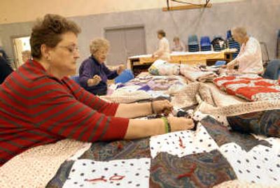 
The Spokesman-Review  Desiree Faller, 50, far left, works on quilts with fellow Piecemakers Irene Olson, 85, left, and Hazel Haidle, 86, far right. It was Navy veteran Faller's idea for the group to sew a patriotic quilt and donate it to the Veterans Affairs Nursing Home.
 (J. Bart Rayniak / The Spokesman-Review)