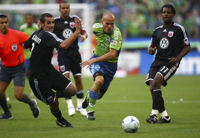 Seattle Sounders’ Freddie Ljungberg powers past D.C. United’s Andrew Jacobson, left, and Luciano Emilio. for the  (Joshua Trujillo for the Associated Press / The Spokesman-Review)