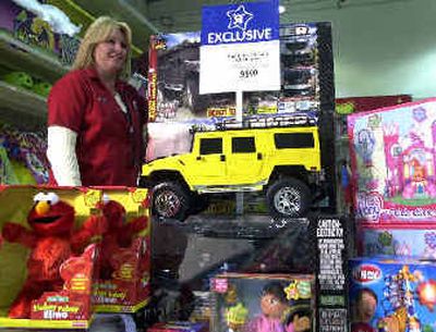
A Toys R Us supervisor with some of the retailer's exclusive toys at the Toys 