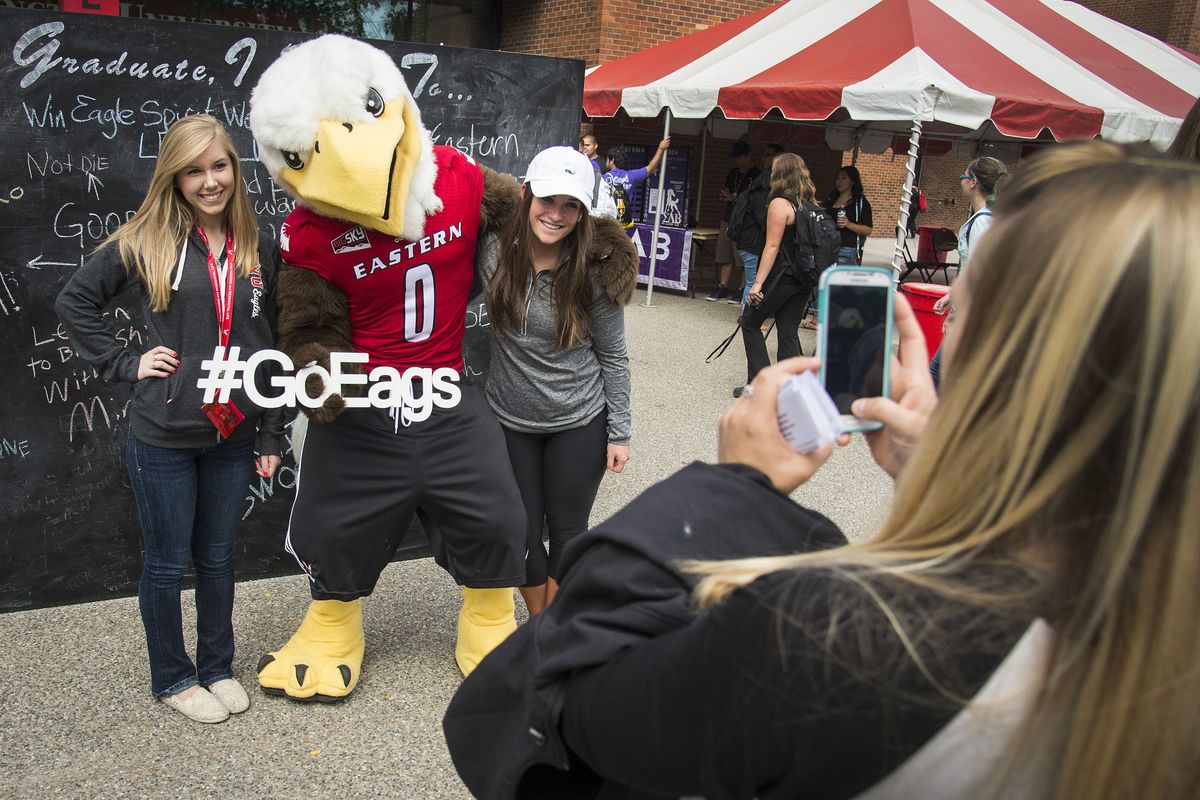 Nicole King, right, of the Eastern Washington University Athletic Department, takes a photo of EWU students Katie Drinkwine, left, Brittney Carey and Eagles mascot Swoop on Wednesday, the first day of fall classes on the Cheney campus. (Colin Mulvany)