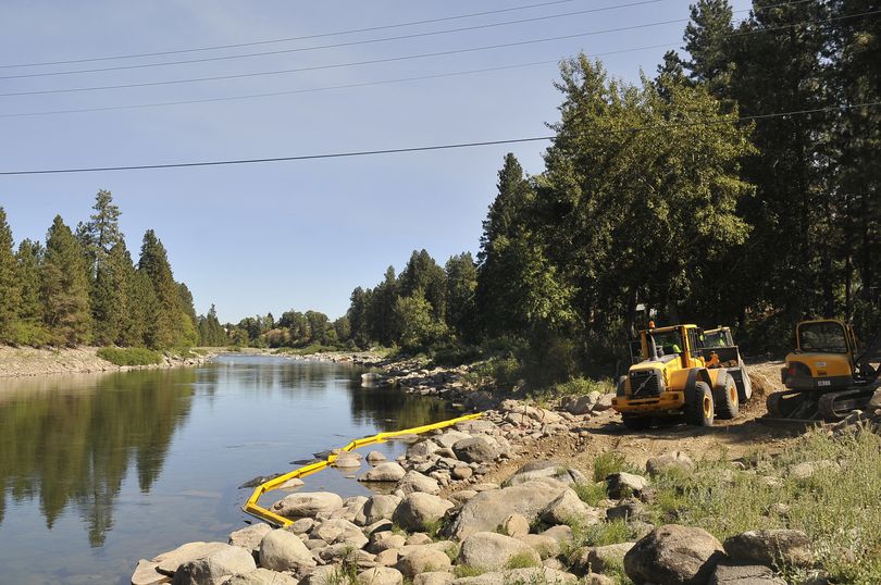 Machines operated by Piersol Construction scrape dirt from the Flora Road landing along the Spokane River on Thursday. (Jesse Tinsley)