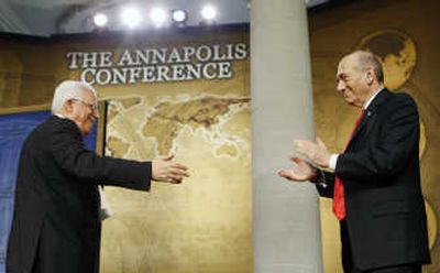 
Palestinian President Mahmoud Abbas, left, reaches to shake hands with Israeli Prime Minister Ehud Olmert during the opening session of Mideast peace conference in Annapolis, Md., Tuesday. Associated Press
 (Associated Press / The Spokesman-Review)