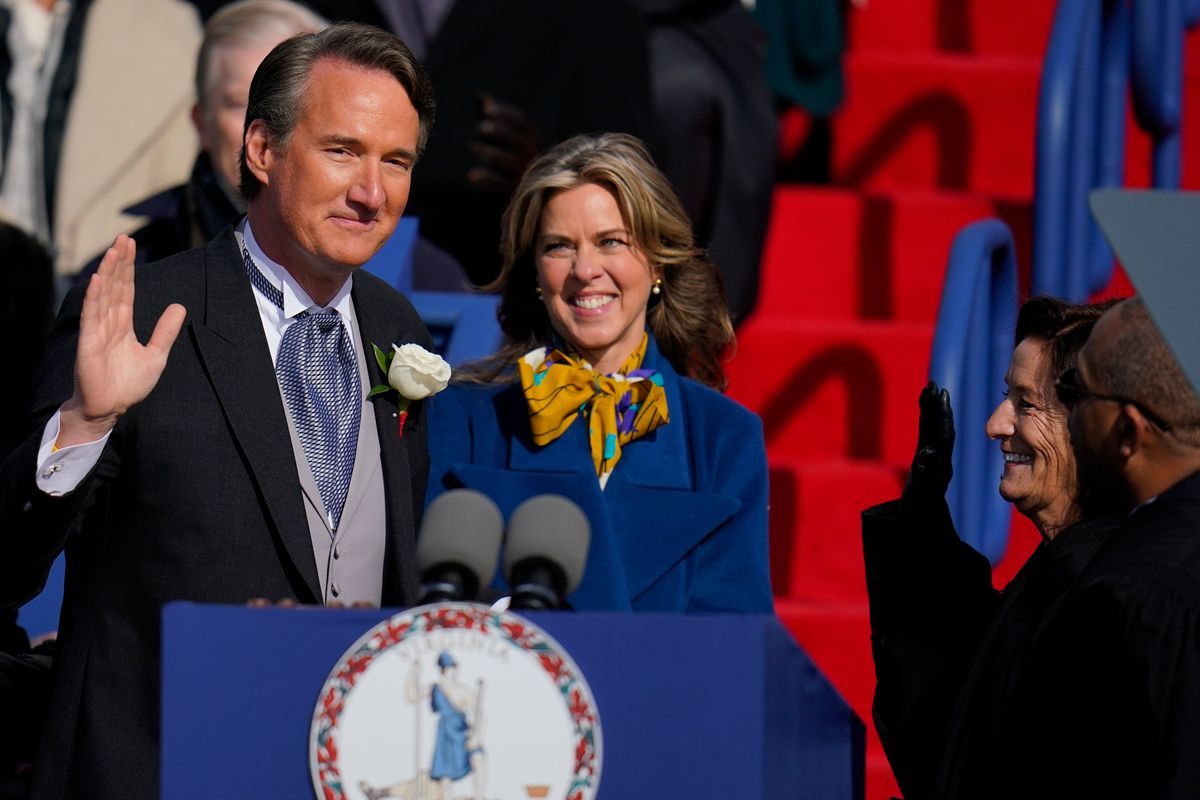 Gov. Glenn Youngkin, with wife Suzanne Youngkin takes the oath of office during an inauguration ceremony, Saturday, Jan. 15, 2022, in Richmond, Va.  (Julio Cortez)