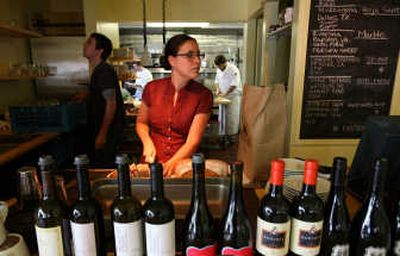 
Bottles of house wine are lined up and the bread is prepared for the dinner rush at Tilth.
 (TPN / The Spokesman-Review)