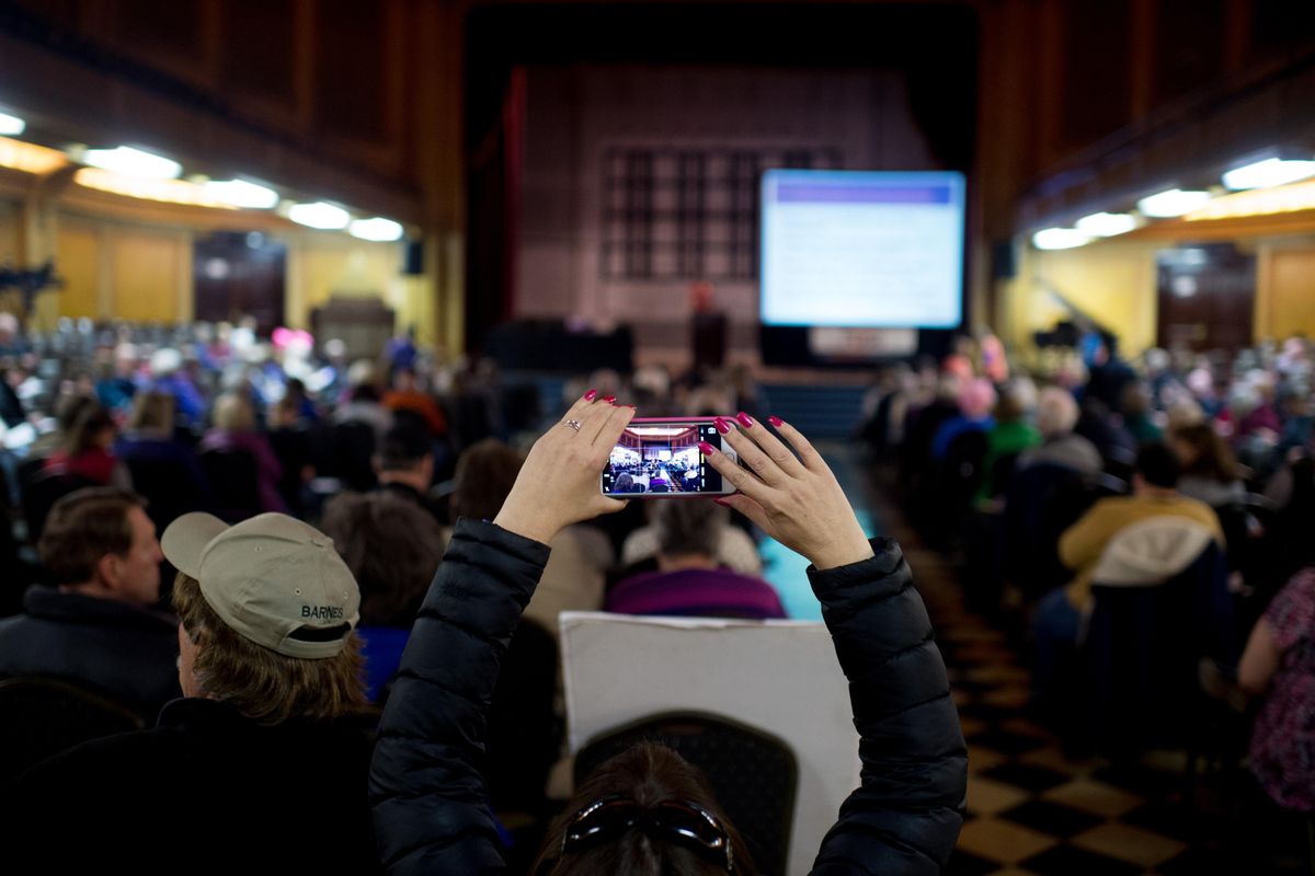 An attendee snaps a photo before the start of a town hall with Rep. Cathy McMorris Rodgers’ Staff on Tuesday, Feb. 28, 2017, at Riverside Place in Spokane, Wash. (Tyler Tjomsland / The Spokesman-Review)