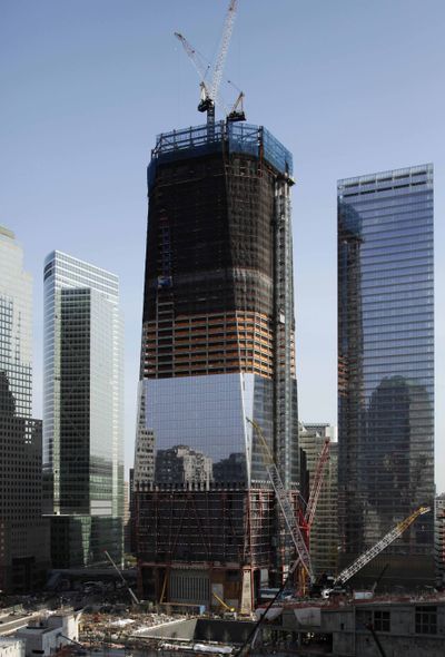 A pair of construction cranes work on top of what will be the 1,776-foot 1 World Trade Center in New York on April 15. (Associated Press)