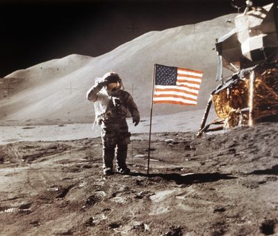 In this July 30, 1971, photo made available by NASA, Apollo 15 Lunar Module Pilot James B. Irwin salutes while standing beside the fourth American flag planted on the surface of the moon. On Tuesday, March 26, 2019, Vice President Mike Pence called for landing astronauts on the moon within five years. (NASA)