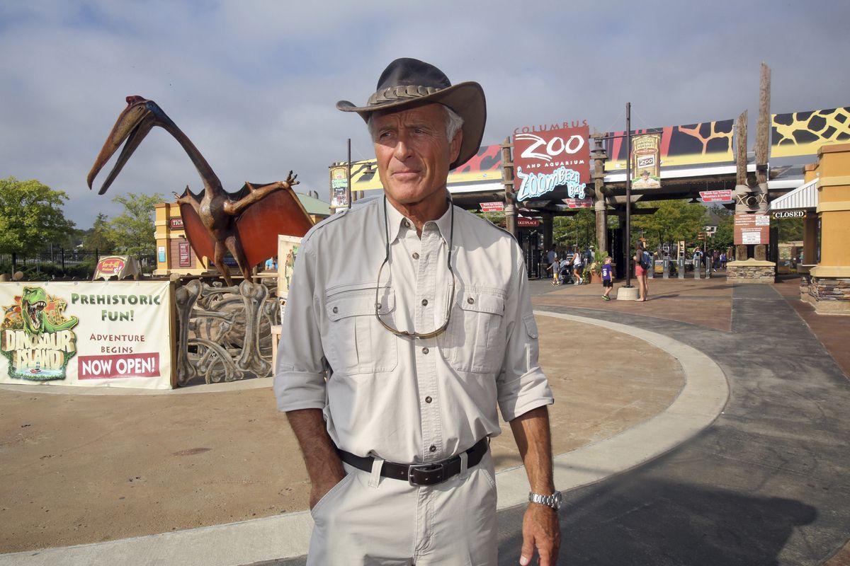 In this Sept. 5, 2013, file photo, Jack Hanna stands at the front entrance of the Columbus Zoo and Aquarium in Powell, Ohio. It