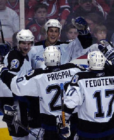 Tampa Bay's Vincent Lacavalier, rear, celebrates with teammates after third-period goal.
(Associated Press / The Spokesman-Review)