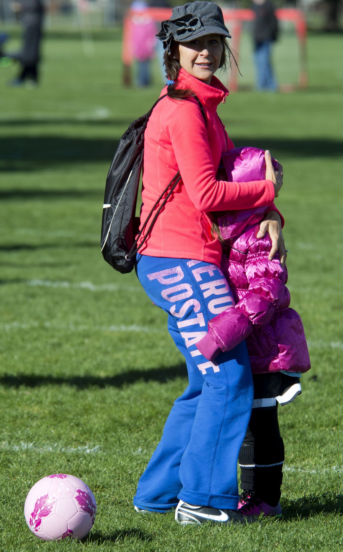 Lori Kassel tries to shield her daughter, Abi, from the frigid wind before the start of Spokane Youth Sports Association U-5 SoccerTots first practice, Saturday at the South Complex in Spokane. Kassel played soccer in high school and college and wanted Abi to play. Mom said Abi’s favorite sport is swimming.