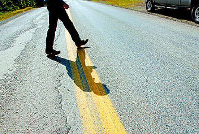 
East Side Highway District supervisor John Pankratz inspects the poor condition of Mullan Trail Road, east of Coeur d'Alene. The district is having a levy election this Tuesday. 
 (Kathy Plonka / The Spokesman-Review)