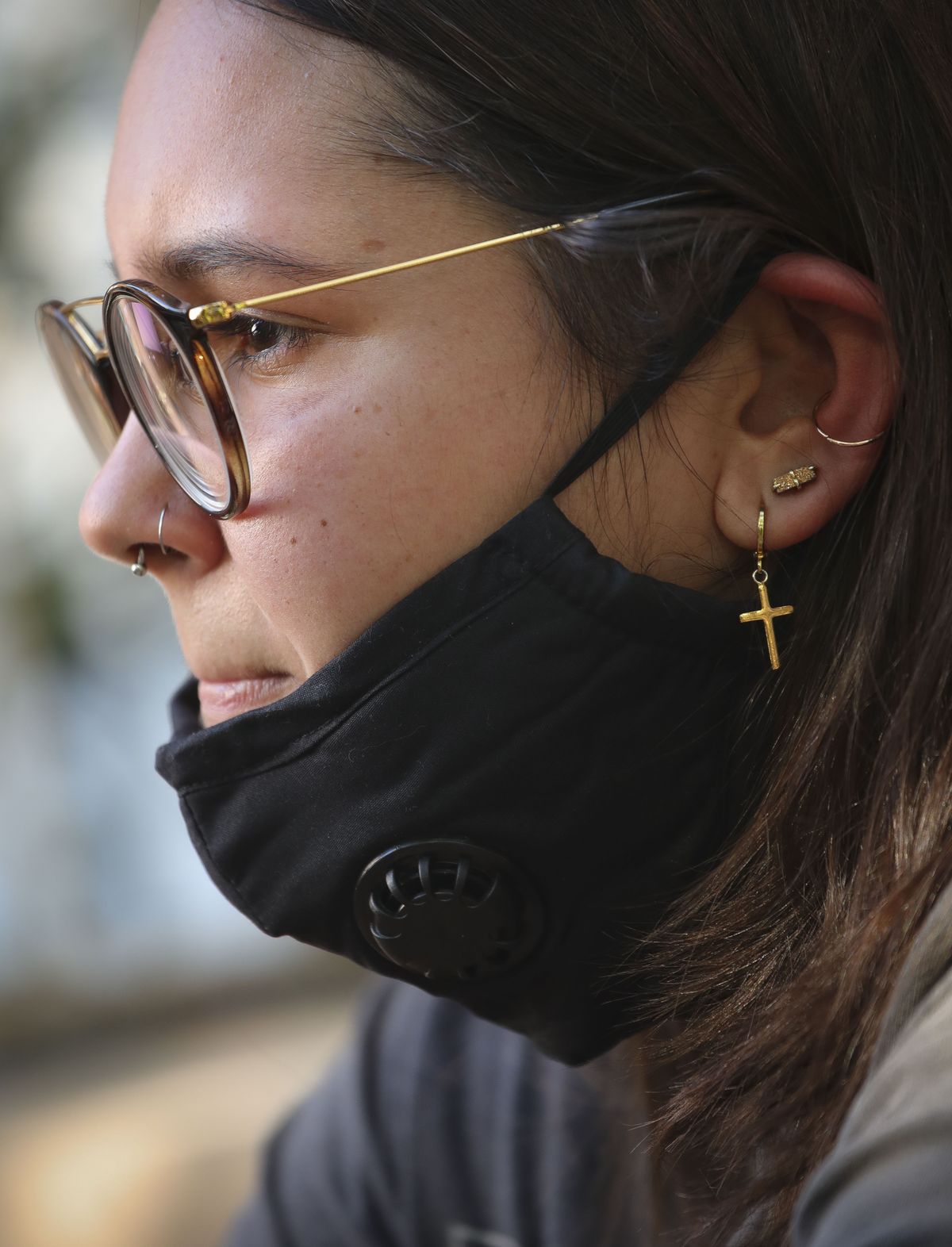 Natalia Afonso, 27, an international student from Brazil at Brooklyn College, sits on a stoop outside her home during an interview, Thursday, July 9, 2020, in New York. Afonso, who is studying teaching education and finished her first semester this spring, said she has lived in the U.S. for 7 years and "I don't see myself moving back to Brazil at this point.  (Bebeto Matthews)