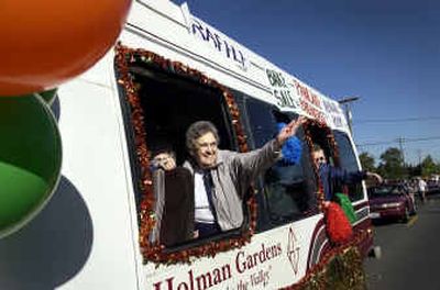 Deede Baugh throws candy to children while riding in the Holman Gardens Retirement bus in the Valleyfest parade last year.
(File/ / The Spokesman-Review)