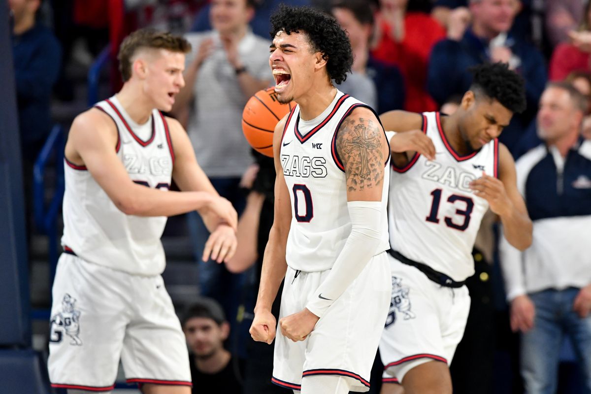 Gonzaga Bulldogs guard Julian Strawther (0) screams in celebration as forward Ben Gregg (33) and guard Malachi Smith (13) celebrate after Smith drew a foul during the second half of a college basketball game on Saturday, Feb 2023, at McCarthey Athletic Center in Spokane, Wash. Gonzaga won the game 88-81.  (Tyler Tjomsland/The Spokesman-Review)