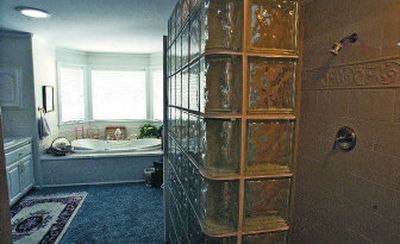 
The Skierka's contractor designed and built by hand the glass block wall as a part of the master bedroom addition. A jacuzzi tub makes for a relaxing setting.
 (Photos by J. BART RAYNIAK / / The Spokesman-Review)