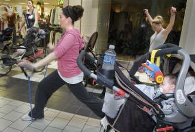 
Bree Vestal, front and center, works with a stretch cord during the Movin' Mommas class at NorthTown Mall. 
 (Photos by CHRISTOPHER ANDERSON / The Spokesman-Review)
