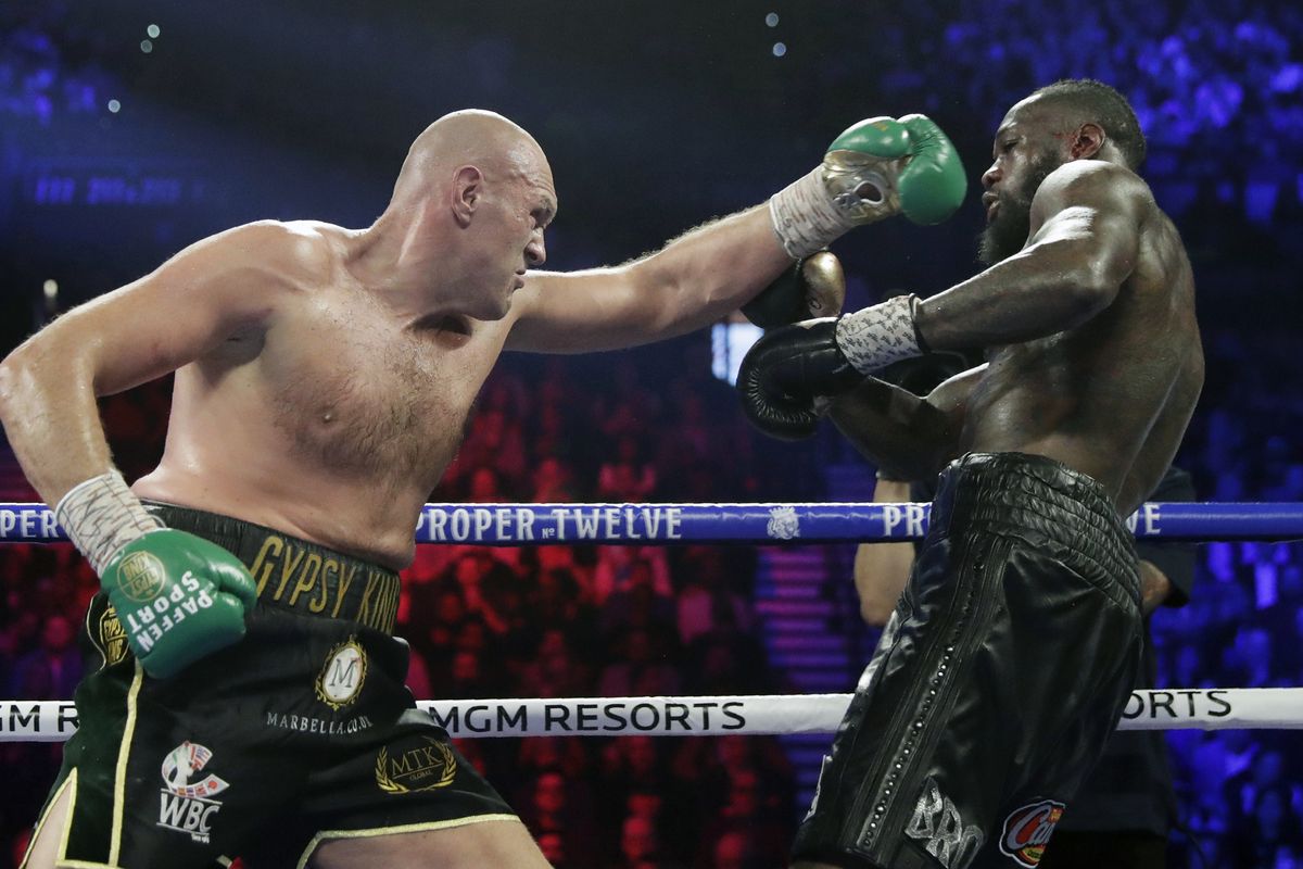 In this Feb. 22, 2020 photo, Tyson Fury, left, of England, fights Deontay Wilder during a WBC heavyweight championship boxing match in Las Vegas. An all-British world heavyweight title showdown between Anthony Joshua and Tyson Fury in 2021 is a step closer. Fury said Wednesday, June 10, 2020, that an agreement has been reached with Joshua