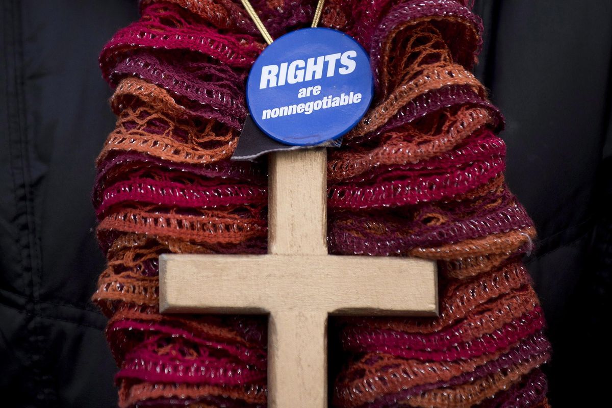 In this Sunday, Jan. 12, 2014, photo, a woman wears a crucifix during a gathering in Montreal, to oppose the proposed Quebec Values Charter. A proposal to ban many public employees from wearing religious symbols, Bill 21, is creating a fiery debate in the Canadian province of Quebec. Bill 21 is Quebec’s fourth legislative attempt since 2011 to regulate the wearing of religious symbols for people working in the public sphere, and for the first time it invokes a constitutional clause allowing local governments to override some constitutional rights. (Graham Hughes/The Canadian Press via AP) ORG XMIT: NYSB507 (Graham Hughes / AP)