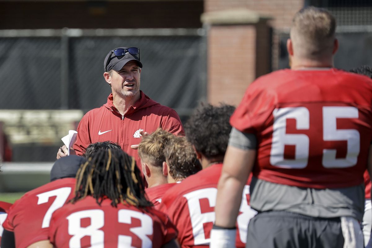 Washington State head football coach Jimmy Rogers talks to his team after the first day of practice Wednesday at Rogers Field in Pullman. (Geoff Crimmins/For The Spokesman-Review)