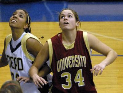 
University High School's #34 Riki Schiermeister battles Mead's Kristina Puthoff for position on rebound during a game Dec. 15.
 (DAN PELLE photos / The Spokesman-Review)