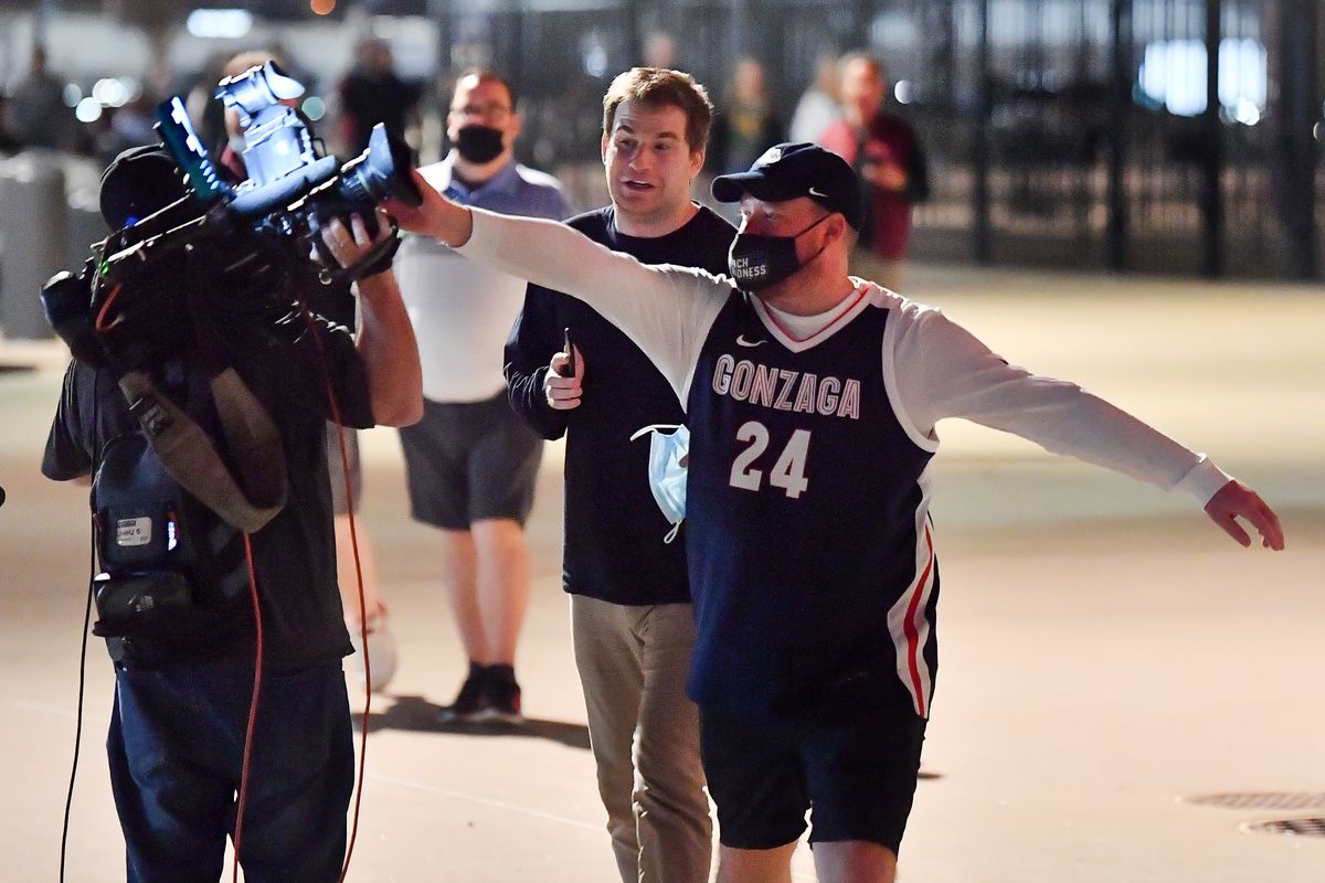 A Gonzaga fan connects with a KIRO 7 cameraman after Gonzaga lost the 2021 NCAA Men's Basketball Championship to Baylor 86-70 on Monday, April 5, 2021, at Lucas Oil Stadium in Indianapolis, Ind.  (Tyler Tjomsland/THE SPOKESMAN-RE)