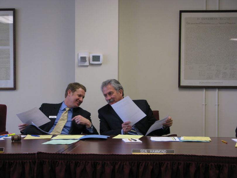 Senate Transportation Chairman John McGee, R-Caldwell, left, and Sen. Jim Hammond, R-Post Falls, right, share a laugh during a Senate Transportation Committee meeting on Tuesday, at which the panel voted to amend two transportation bills to try to add in funding increases. (Betsy Russell / The Spokesman-Review)