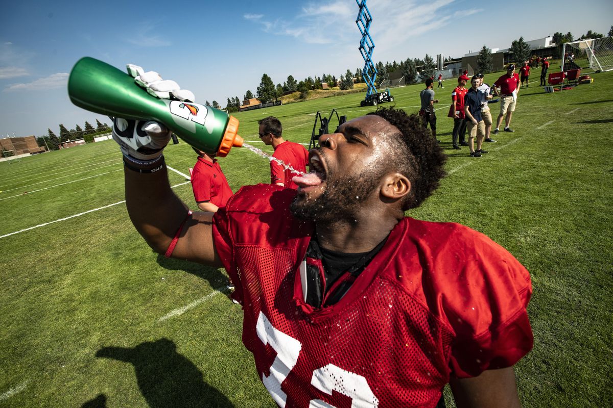 Keeping hydrated, EWU defensive lineman Keith Moore, takes a quick water break during the opening day of college football practice on Monday in Cheney. (Colin Mulvany / The Spokesman-Review)