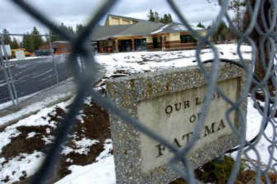 Our Lady of Fatima Church sits behind locked fences Wednesday under gloomy overcast skies.
(Christopher Anderson/ / The Spokesman-Review)