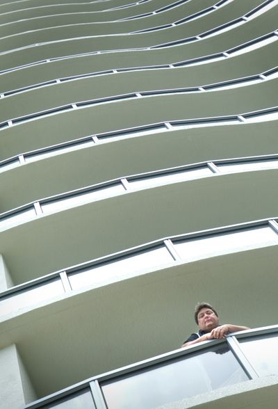 Victor Vangelakos looks out from his seventh-floor apartment balcony in downtown Fort Myers, Fla., last month. (Associated Press / The Spokesman-Review)