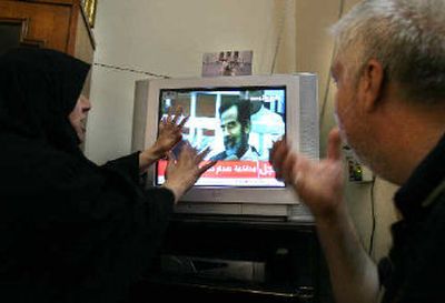 
Adnan Fadil al-Saadi, right, who said his brother was executed in 1982 for being a member of an opposition party, and his wife Eman, left, react with anger, while watching Saddam Hussein's trial on television in Baghdad on Wednesday. 
 (Associated Press / The Spokesman-Review)