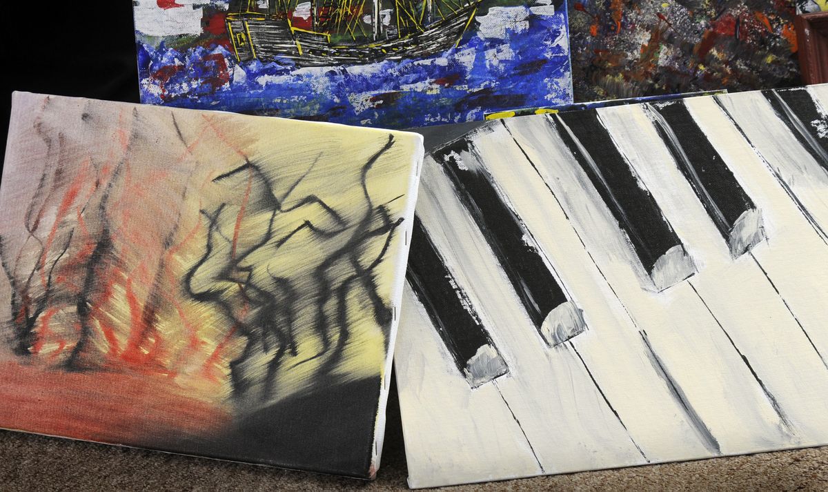 “Running Through the Fields” and ”Fortissimo,” paintings by John Wood (Dan Pelle / The Spokesman-Review)