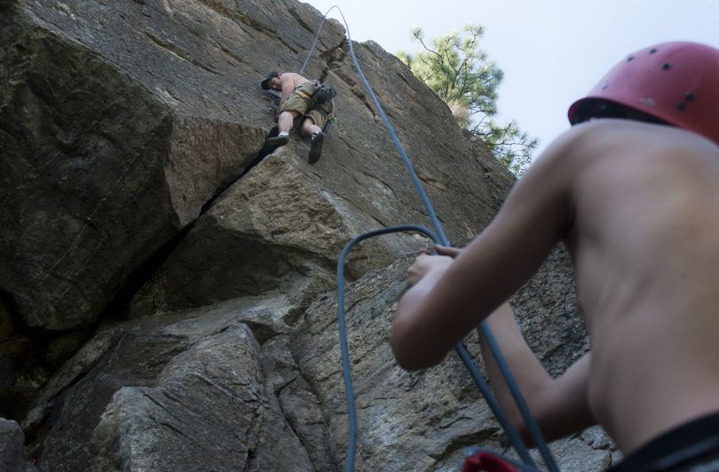Tim Page, of Bellingham, climbs a rock face as his nephew Nathan Pettis, 15, belays on Monday at John H. Shields Park in Spokane. Page, a program coordinator with the American Alpine Institute, was in town to see family and decided to take Pettis climbing. (Tyler Tjomsland)