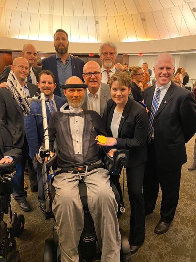 Anne McClain, right, and Steve Gleason, center, pose with Gonzaga Prep alums, left to right from back, Dave Stewart, Jason Rubright, Mike Gleason, Stephen Steigleder, Tony Hazel, H.T. Higgins and Noah Cooper. (Courtesy / Anne McClain)