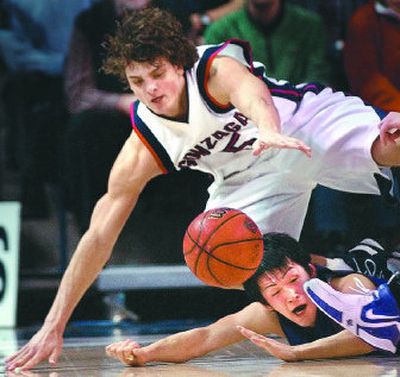 
Gonzaga's Matt Bouldin, top, and Portland's Taishi Ito go to the floor in pursuit of a loose ball Monday night in GU's 20-point win. 
 (Brian Plonka / The Spokesman-Review)