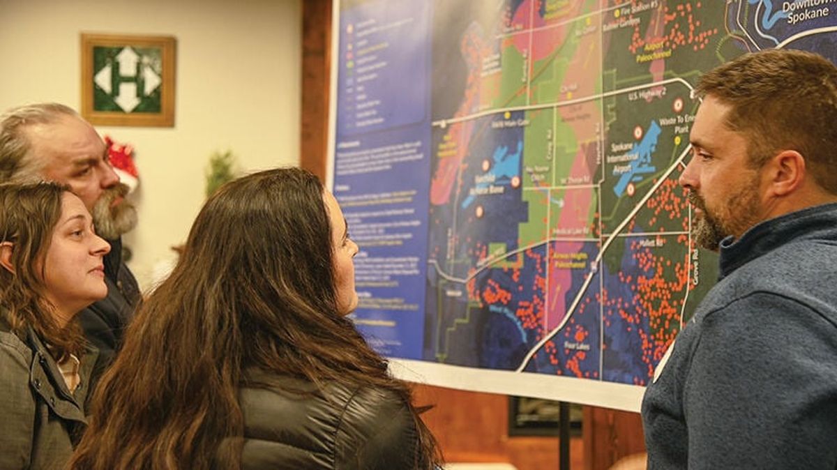 West Plains residents study a map of private wells contaminated with PFAS.  (SSR)