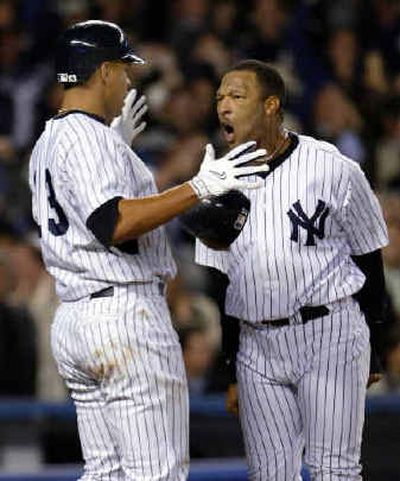
Gary Sheffield, right, greets teammate Alex Rodriguez at home plate after both scored runs.
 (Associated Press / The Spokesman-Review)