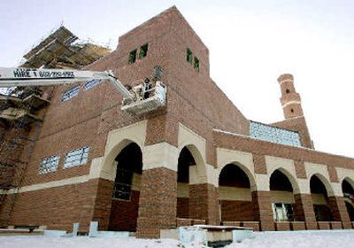 
A crane sits alongside Boston's unfinished mosque and cultural center being built in the city's Roxbury district earlier this year. The original completion date for the mosque was November 2004. 
 (Associated Press / The Spokesman-Review)