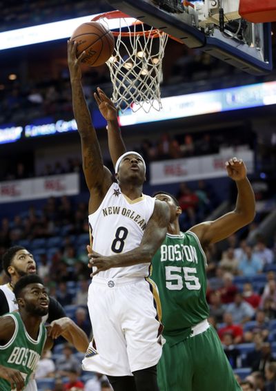 New Orleans Pelicans guard Archie Goodwin, center, goes to the basket against Boston Celtics forward Jordan Mickey, right, in the first half of an NBA basketball game in New Orleans, Monday, Nov. 14, 2016. (Gerald Herbert / Associated Press)