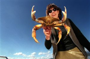 Meredith Heick of Spokane is looking forward to dinner with this keeper Dungeness crab from Hood Canal. (Rich Landers / The Spokesman-Review)