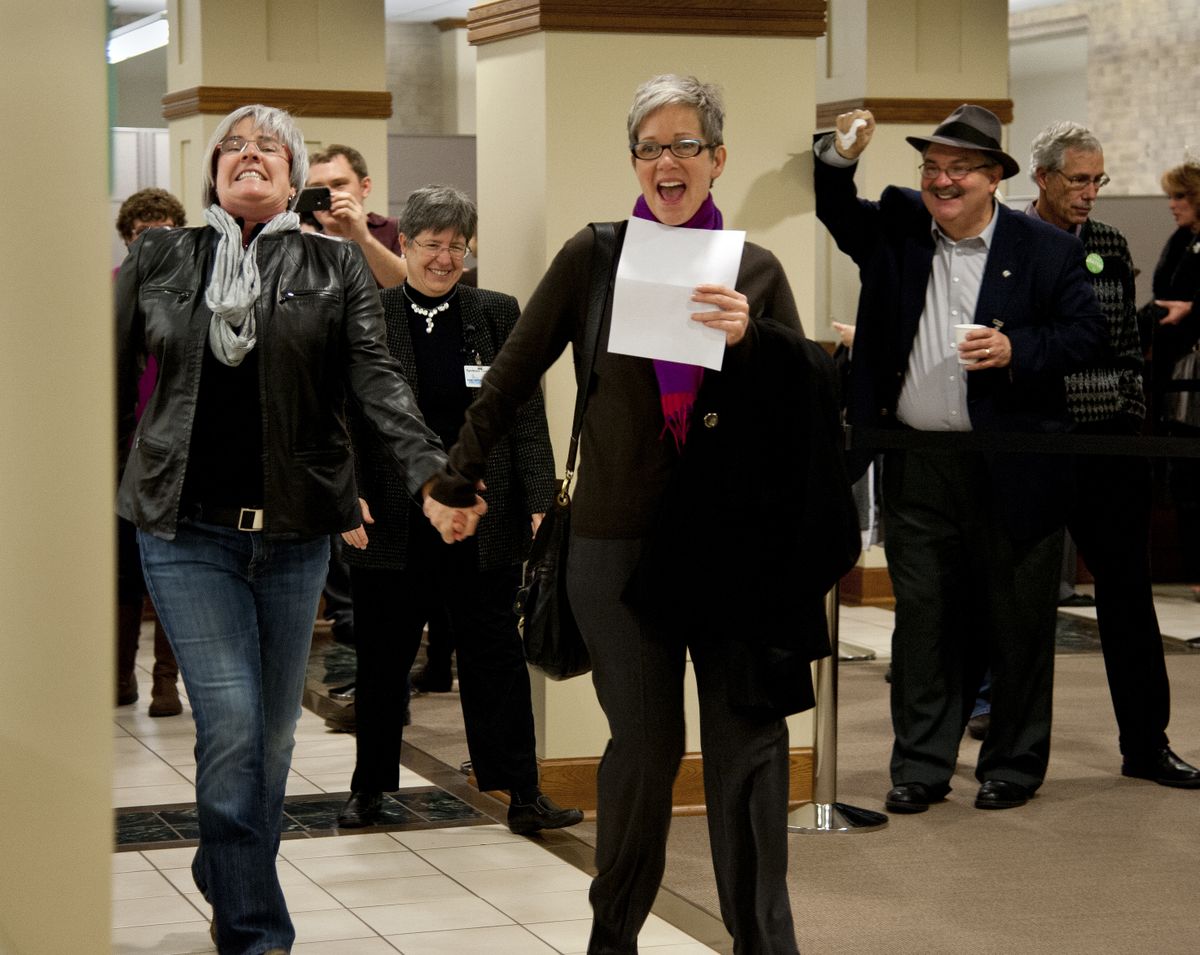 Margaret Witt, left, and Laurie Johnson approach the counter to obtain a marriage license at the Spokane County Courthouse. (Dan Pelle)