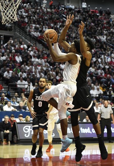 Gonzaga forward Rui Hachimura sizes up San Diego State guard Devin Watson before blocking his shot in the second half Thursday in San Diego. (DENIS POROY / AP)