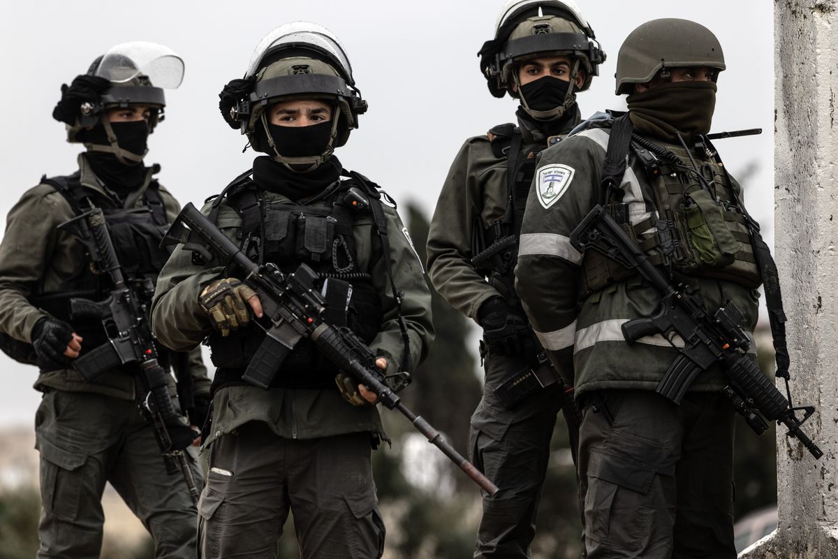 Israeli soldiers watch as Palestinians cross the Qalandia Israeli military checkpoint to travel to Jerusalem’s Al-Aqsa Mosque for the first Friday noon prayers during the Muslim holy month of Ramadan in March. MUST CREDIT: Heidi Levine/For The Washington Post  (Heidi Levine/FTWP)