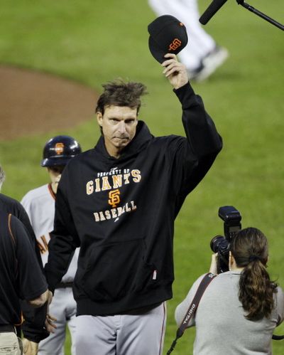 San Francisco Giants starting pitcher  Randy  Johnson acknowledges the crowd after earning his 300th career win in the Giants 5-1 victory over the Washington Nationals in a baseball game Thursday, June 4, 2009, in Washington.  (Associated Press)