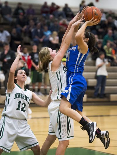 East Valley’s Hannah Burland, defending Pullman’s Anne Mari Petrino, has led the Knights back to the state tournament for the third straight season. (Colin Mulvany / The Spokesman-Review)