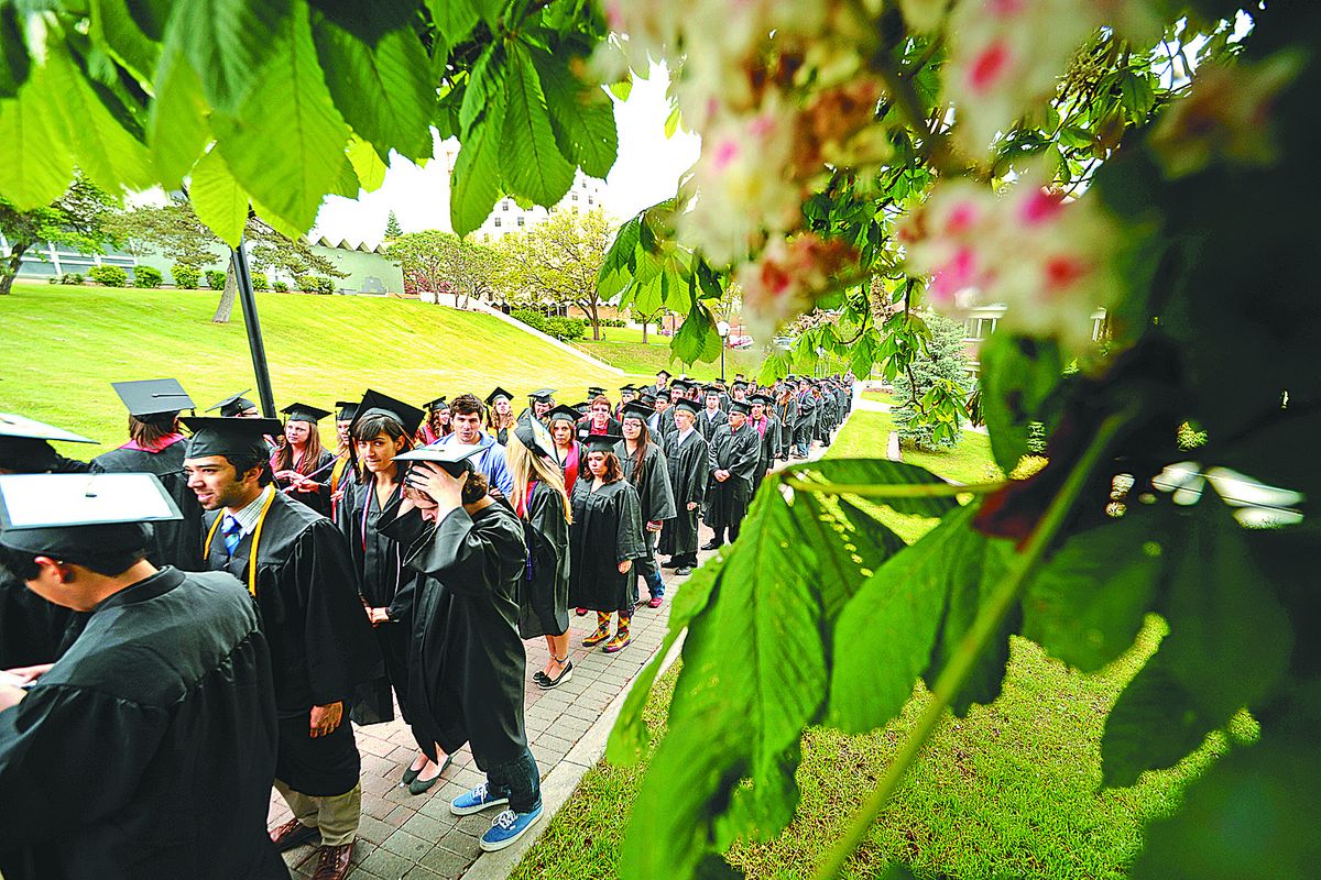  Eastern Washington University bachelor’s degree graduates make their way to Woodward Field for Friday’s commencement ceremony.  (Colin Mulvany)