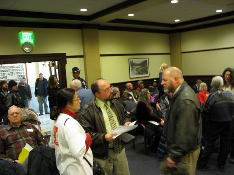 Occupy Boise supporters mill around in the House State Affairs Committee meeting room on Friday morning, during a delay in proceedings as lawmakers head back to the House floor. (Betsy Russell)