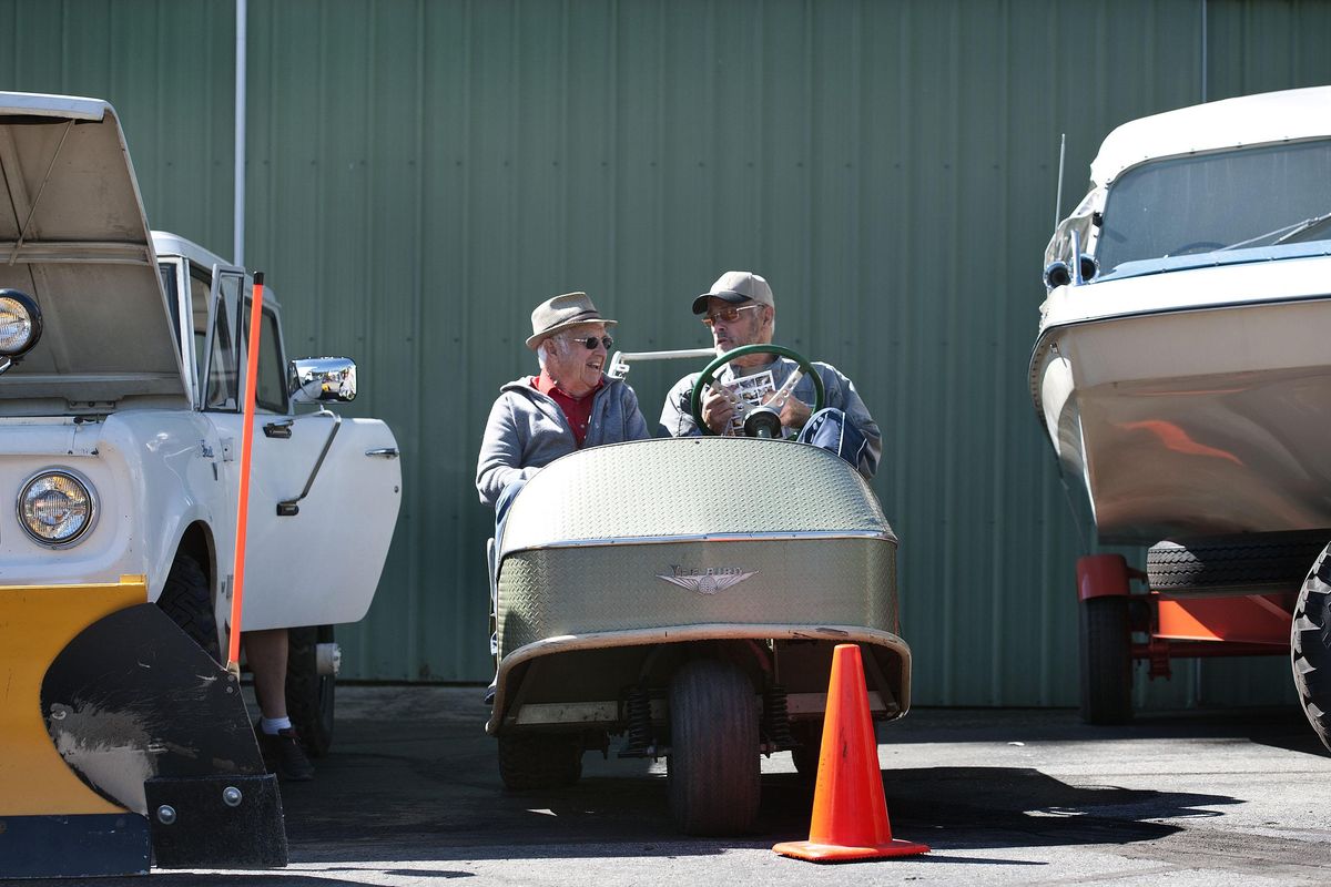 Vern Eden, of Valleyford, left, and Leo Welter, of Spokane Valley, talk about auction items while sitting in an old golf cart before the startof the Drs. Forrest and Pamela Bird estate sale and auction at the Bird Aviation Museum and Invention Center in Sagle, Idaho, on Saturday, April 29, 2017. (Kathy Plonka / The Spokesman-Review)